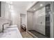 Modern bathroom featuring double sinks, a glass-enclosed shower, and sleek design at 8312 N Golf Dr, Paradise Valley, AZ 85253
