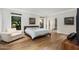 Bright bedroom with wood floors, neutral walls, natural light, and modern furniture at 8312 N Golf Dr, Paradise Valley, AZ 85253