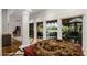 Elegant foyer with stone floors, decorative dragon table, and views of the backyard oasis at 8312 N Golf Dr, Paradise Valley, AZ 85253