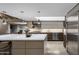 Contemporary kitchen with a large center island, stainless steel appliances, and modern cabinetry at 8312 N Golf Dr, Paradise Valley, AZ 85253