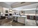 Open-concept kitchen featuring a large island, modern cabinets, and stainless steel appliances with a living room view at 8312 N Golf Dr, Paradise Valley, AZ 85253