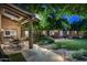 Cozy covered patio featuring exposed beams, dining area, and lush greenery at 8312 N Golf Dr, Paradise Valley, AZ 85253