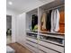 Organized walk-in closet with custom shelving, drawers, and hanging space for clothing and accessories at 8312 N Golf Dr, Paradise Valley, AZ 85253
