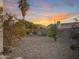 Desert landscaped backyard with mature trees, shrubbery and rock ground cover at 8339 W Bluefield Ave, Peoria, AZ 85382