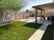 Backyard with patio and artificial grass at 8981 W Tuckey Ln, Glendale, AZ 85305