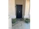 Inviting front entry featuring a secure black screen door and charming potted plants at 8981 W Tuckey Ln, Glendale, AZ 85305