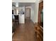 Hallway with wood floors, leading to the kitchen, front door, and other rooms of the house at 8981 W Tuckey Ln, Glendale, AZ 85305