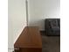 Partial view of a living room with a long console table and sectional sofa and a doorway to the outside at 8981 W Tuckey Ln, Glendale, AZ 85305