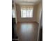 Bright living area featuring hardwood floors and natural light, providing a versatile space for relaxation and entertainment at 8981 W Tuckey Ln, Glendale, AZ 85305