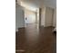 Bright living room featuring wood-look tile floors and an arched entry at 8981 W Tuckey Ln, Glendale, AZ 85305