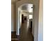 Arched entry to living room with wood-look tile, and a fireplace at 8981 W Tuckey Ln, Glendale, AZ 85305