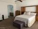 Comfortable main bedroom featuring an attached bathroom, soft carpet, and a ceiling fan at 8981 W Tuckey Ln, Glendale, AZ 85305