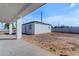 Unfinished backyard shows white stucco walls and a concrete patio in a new build at Xxx S Hunt Hwy, Queen Creek, AZ 85142