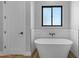 Elegant bathroom featuring a freestanding tub, a black-framed window, and a modern design at Xxx S Hunt Hwy, Queen Creek, AZ 85142