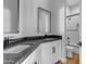 Bright bathroom features dual sinks, dark countertops, white cabinets, and walk-in shower at Xxx S Hunt Hwy, Queen Creek, AZ 85142