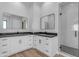 Well-lit bathroom featuring double vanities, square mirrors, granite counters, and modern glass enclosed shower at Xxx S Hunt Hwy, Queen Creek, AZ 85142