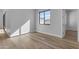 Bright bedroom with wood-look floors, neutral paint, a bright window, and modern baseboards at Xxx S Hunt Hwy, Queen Creek, AZ 85142