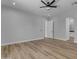 Spacious bedroom features wood-look floors, a modern ceiling fan, and ample natural light at Xxx S Hunt Hwy, Queen Creek, AZ 85142