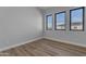 Bright bedroom features modern windows and light wood-look flooring at Xxx S Hunt Hwy, Queen Creek, AZ 85142