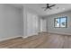Well-lit bedroom boasts wood-look floors, a ceiling fan, closet doors, and a window providing ample light at Xxx S Hunt Hwy, Queen Creek, AZ 85142