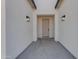 Contemporary entryway with white walls, lighting fixtures, and a front door at Xxx S Hunt Hwy, Queen Creek, AZ 85142