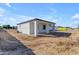Modern home exterior with covered patio in a partially landscaped backyard at Xxx S Hunt Hwy, Queen Creek, AZ 85142