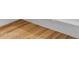 Close up of new light colored wood-look flooring and modern baseboards at Xxx S Hunt Hwy, Queen Creek, AZ 85142