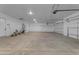 Spacious garage featuring concrete floors, recessed lighting, and two garage doors at Xxx S Hunt Hwy, Queen Creek, AZ 85142