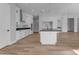 Bright kitchen featuring white cabinets and a large island with black countertop at Xxx S Hunt Hwy, Queen Creek, AZ 85142