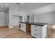 Kitchen island with light colored wood cabinets, dark countertops, and black fixtures at Xxx S Hunt Hwy, Queen Creek, AZ 85142