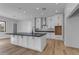 New kitchen with a large island, white cabinets, black countertops and hardwood floors at Xxx S Hunt Hwy, Queen Creek, AZ 85142