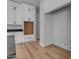 Bright kitchen featuring white cabinets with modern hardware and hardwood floors at Xxx S Hunt Hwy, Queen Creek, AZ 85142