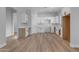 New kitchen features white cabinets, sink, new appliances, and wood-look flooring at Xxx S Hunt Hwy, Queen Creek, AZ 85142