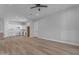 Open-concept living area with wood flooring and recessed lighting leading to kitchen at Xxx S Hunt Hwy, Queen Creek, AZ 85142