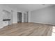 Spacious and airy living room with wood-look floors, modern recessed lights, and neutral paint at Xxx S Hunt Hwy, Queen Creek, AZ 85142