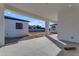Covered patio displays concrete floors and white support posts in a new construction home at Xxx S Hunt Hwy, Queen Creek, AZ 85142
