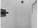 Modern shower featuring sleek subway tile, matte black fixtures, and a convenient built-in niche at Xxx S Hunt Hwy, Queen Creek, AZ 85142