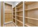 Walk-in closet features custom wood shelves and hanging racks at Xxx S Hunt Hwy, Queen Creek, AZ 85142