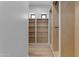 Walk-in closet features custom wood shelves and hanging racks at Xxx S Hunt Hwy, Queen Creek, AZ 85142