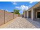 Spacious backyard with paver flooring, a block wall, and a covered patio area at 10134 E Talon Ave, Mesa, AZ 85212