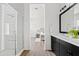 Modern bathroom with glass enclosed shower, and double vanity with black cabinets at 10134 E Talon Ave, Mesa, AZ 85212