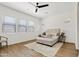 Bright bedroom with a neutral color palette, large windows, ceiling fan, and comfortable seating area at 10134 E Talon Ave, Mesa, AZ 85212