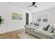 Bright bedroom with a stylish bed frame, ceiling fan, and an ensuite bathroom at 10134 E Talon Ave, Mesa, AZ 85212