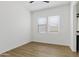 Empty bedroom featuring wood-look floors, a ceiling fan and two windows for natural light at 10134 E Talon Ave, Mesa, AZ 85212