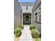 Charming front entrance with decorative shrubs along the walkway and stylish shutters at 10134 E Talon Ave, Mesa, AZ 85212