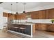 Spacious kitchen island with barstool seating, pendant lighting, stainless appliances, and modern cabinetry at 10134 E Talon Ave, Mesa, AZ 85212