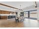 Modern kitchen with stainless steel appliances, large island, and dining area featuring a sliding glass door to the backyard at 10134 E Talon Ave, Mesa, AZ 85212
