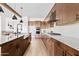 Modern kitchen features wood cabinets, stainless appliances, granite countertops, and subway tile backsplash at 10134 E Talon Ave, Mesa, AZ 85212
