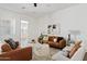 Comfortable living room with neutral color palette, plush seating, and bright natural light creates an inviting space at 10134 E Talon Ave, Mesa, AZ 85212