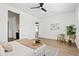 Bright main bedroom features hardwood floors, ceiling fan, and modern décor at 10134 E Talon Ave, Mesa, AZ 85212